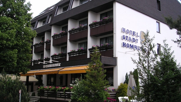 Un hôtel doté de plusieurs balcons, d’un restaurant et d’une enseigne indiquant qu’il s’agit d’un hôtel et d’un restaurant.