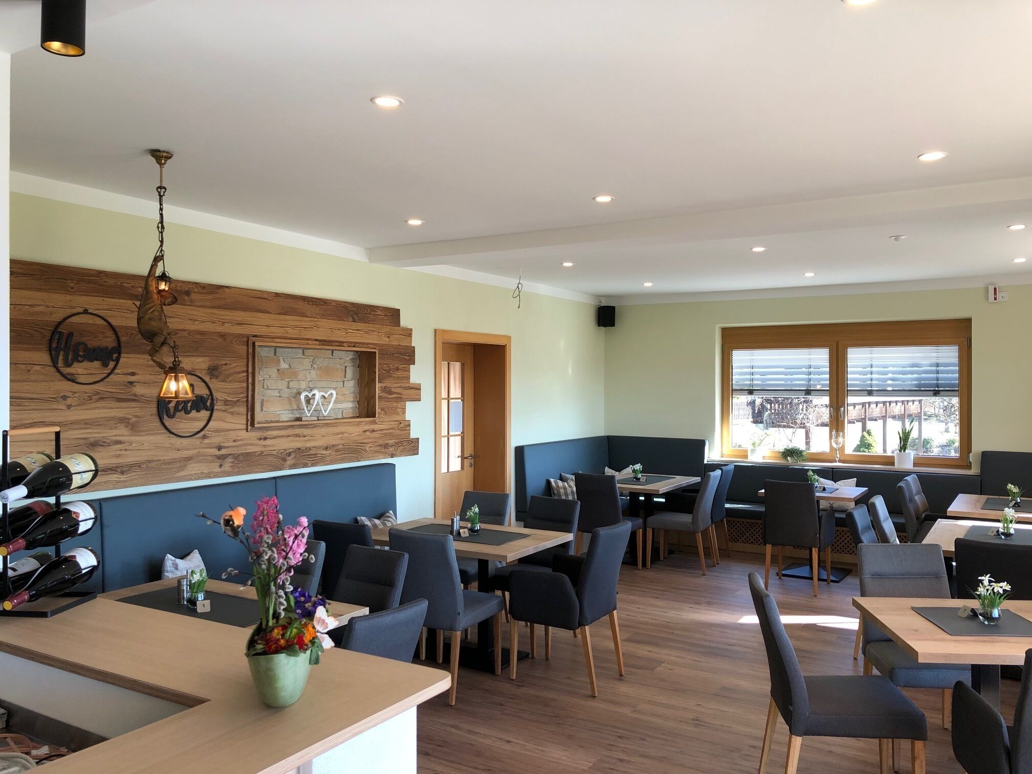 A restaurant with wooden accents, a bar area, and seating arrangements.