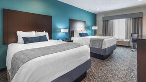 A hotel room with two beds, a desk, and a large window with curtains. - Best Western Plus Owensboro (Owensboro)