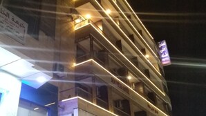 A multi-story building with balconies and a sign for 'NOKIA Care' at the bottom. - Ahla Tlah SeaView Hotel (Aqaba)