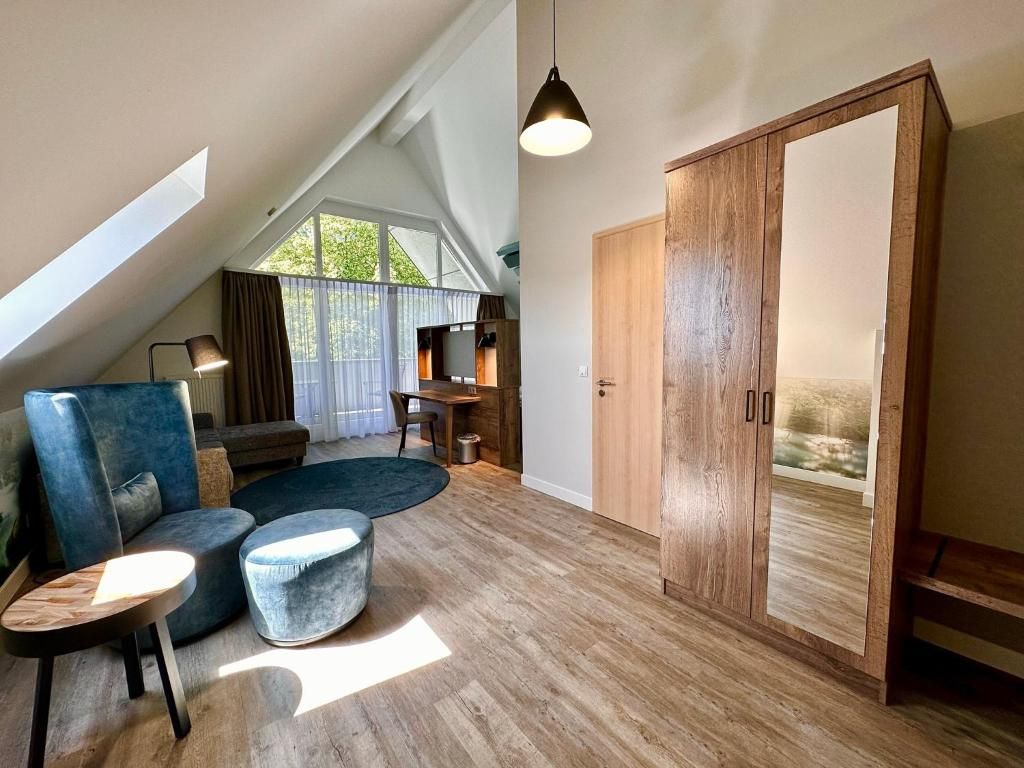 Una sala moderna con techo estilo loft, un amplio armario de madera y un comedor con mesa y sillas.