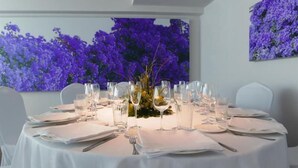 A round dining table set for six with white tablecloths, silverware, and clear glasses. - LOS Guardeses (Medio Cudeyo)
