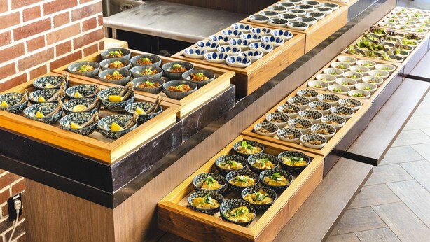 A buffet with various dishes arranged in trays. - KOKO HOTEL Akabane Station (Tokyo)
