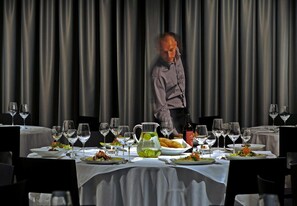 A dining table set with multiple plates of food, glasses, and a pitcher of water. - Silver Hotel Gokart Center (Szczecin)