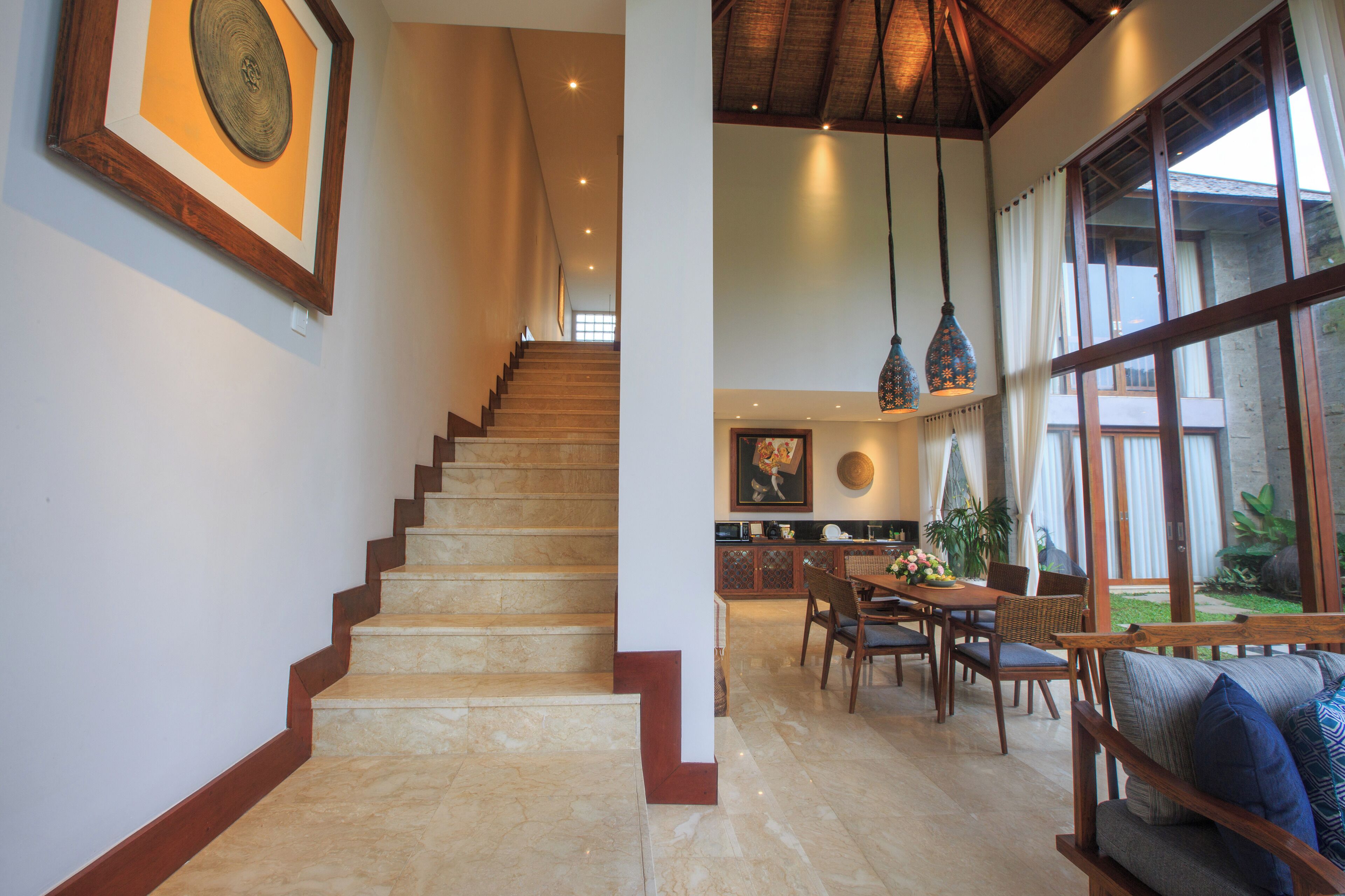 A staircase leading to a dining area with a view of the outdoors.