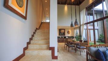 A staircase leading to a dining area with a view of the outdoors.