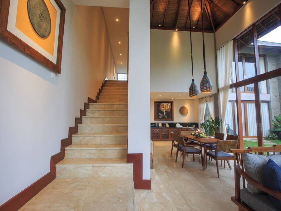 A staircase leading to a dining area with a view of the outdoors.