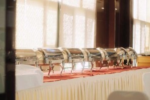 A row of buffet-style tables with metal serving trays. - Huangshan Scholars Conference Hotel (Xiuning)