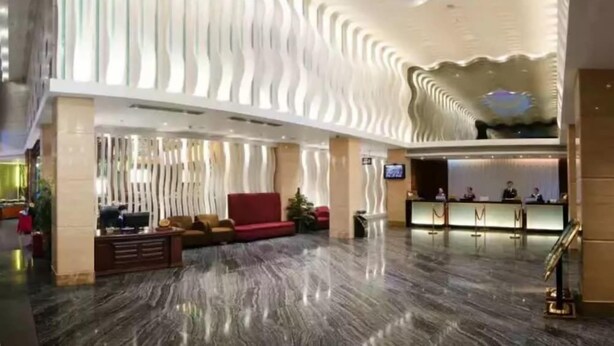 A spacious lobby with a modern design, featuring a marble floor and a unique ceiling with light patterns. - Shenzhen Pengker Deluxe Collection Hotel (Shenzhen)