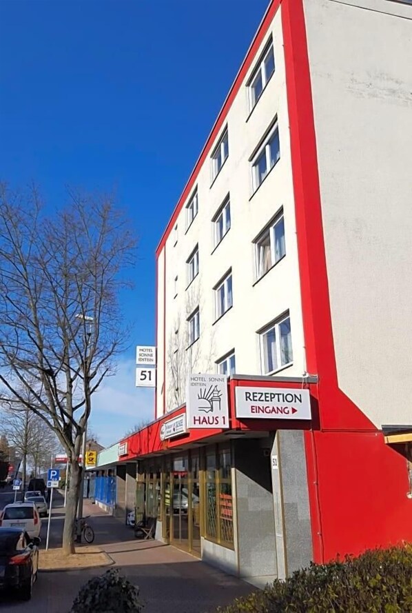 A hotel building with a reception area and a sign indicating room number 51.