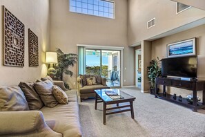 Palm Villas at Mauna Lani Unit F22 - 2 Bedroom w/Loft, 2 Bath, Garden View | Living area | 32-inch TV with cable channels - Kohala Coast Vacation Rental by OUTRIGGER (Waikoloa)