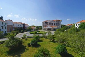 A residential area with multiple buildings, a roundabout, and green spaces. - Yue Feng Yuan Hotel (Fengkai)