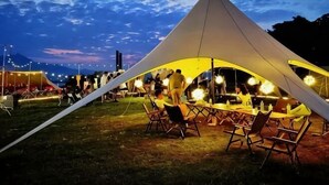 A large tent with a dining area, tables, and chairs. - Yue Feng Yuan Hotel (Fengkai)