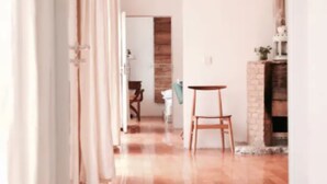 A spacious room with a tiled floor, a wooden chair, and a small table. - Beijing Migrator Mountain Resort (Changping)