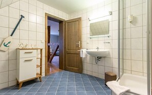 A bathroom with a sink, mirror, and blue-tiled floor. - Gasthof Obere Mühle (Blankenburg)