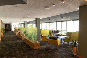 A modern office space with a long reception area, seating arrangements, and large windows providing natural light. - Gut Matheshof BW Signature Collection (Rieden)