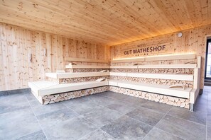 A wooden interior with a reception desk and a sign reading "Hotel Gut Matheshof." - Gut Matheshof BW Signature Collection (Rieden)