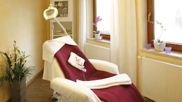 Medical examination room with a reclining chair, dental light, and window with an outside view.