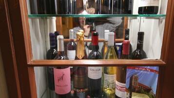 A wine rack with multiple shelves holding various bottles of wine.