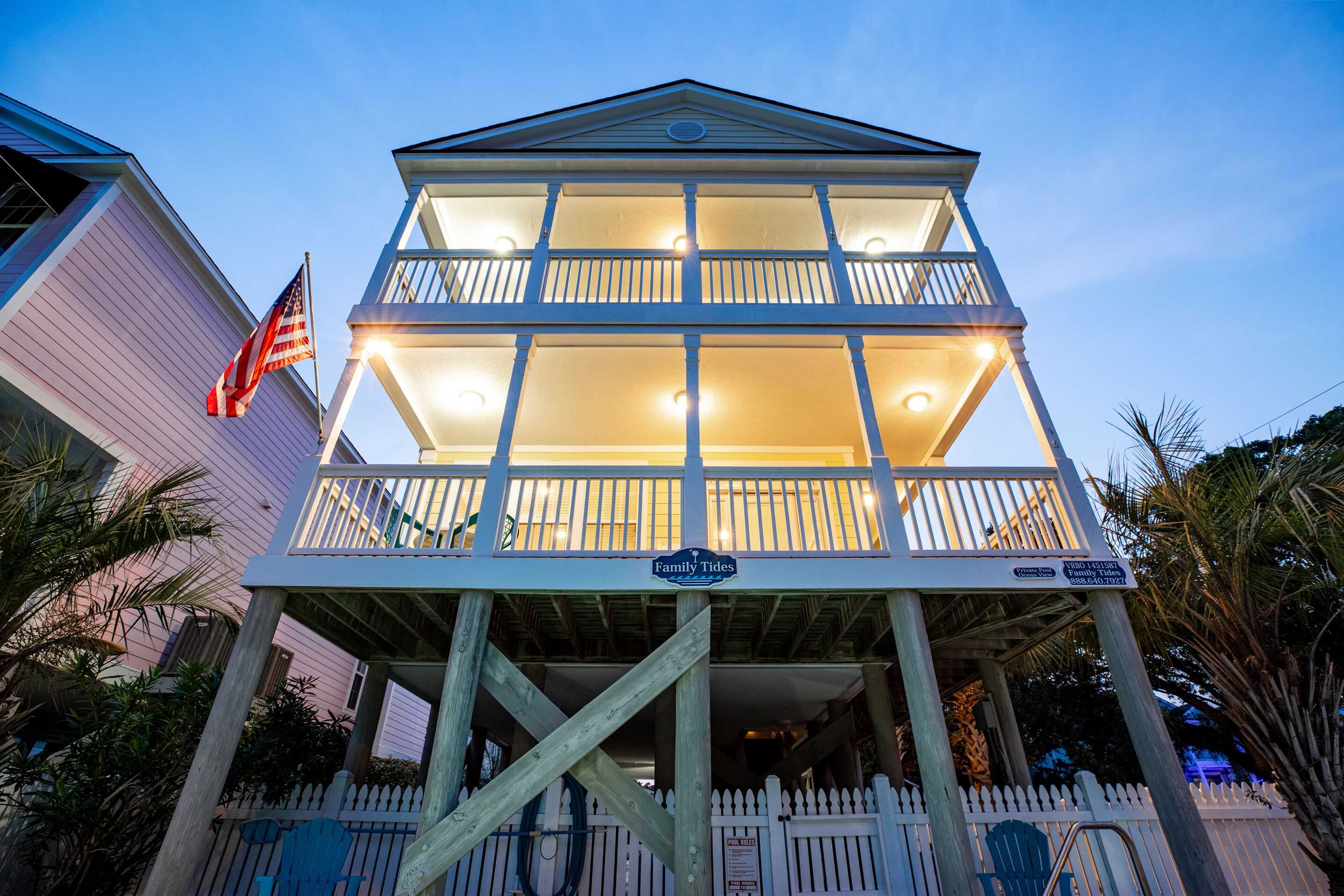 A two-story wooden structure with a balcony, a flag, and a sign reading "Family Tides."