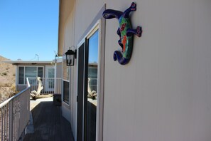 Enjoy breathtaking desert views from this balcony with a glass door leading to a spacious interior.