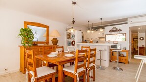 A dining area with wooden furniture, a mirror, and a plant.