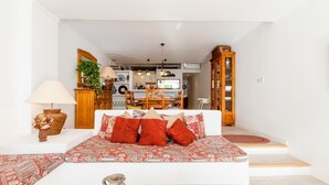 A living room with a sofa, a lamp, a vase, and a coffee table.
