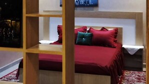 A bedroom with a bed, a nightstand, a shelf with a basket, and a wall-mounted lamp. - ^^ Superb apt near the beach  (Agadir)