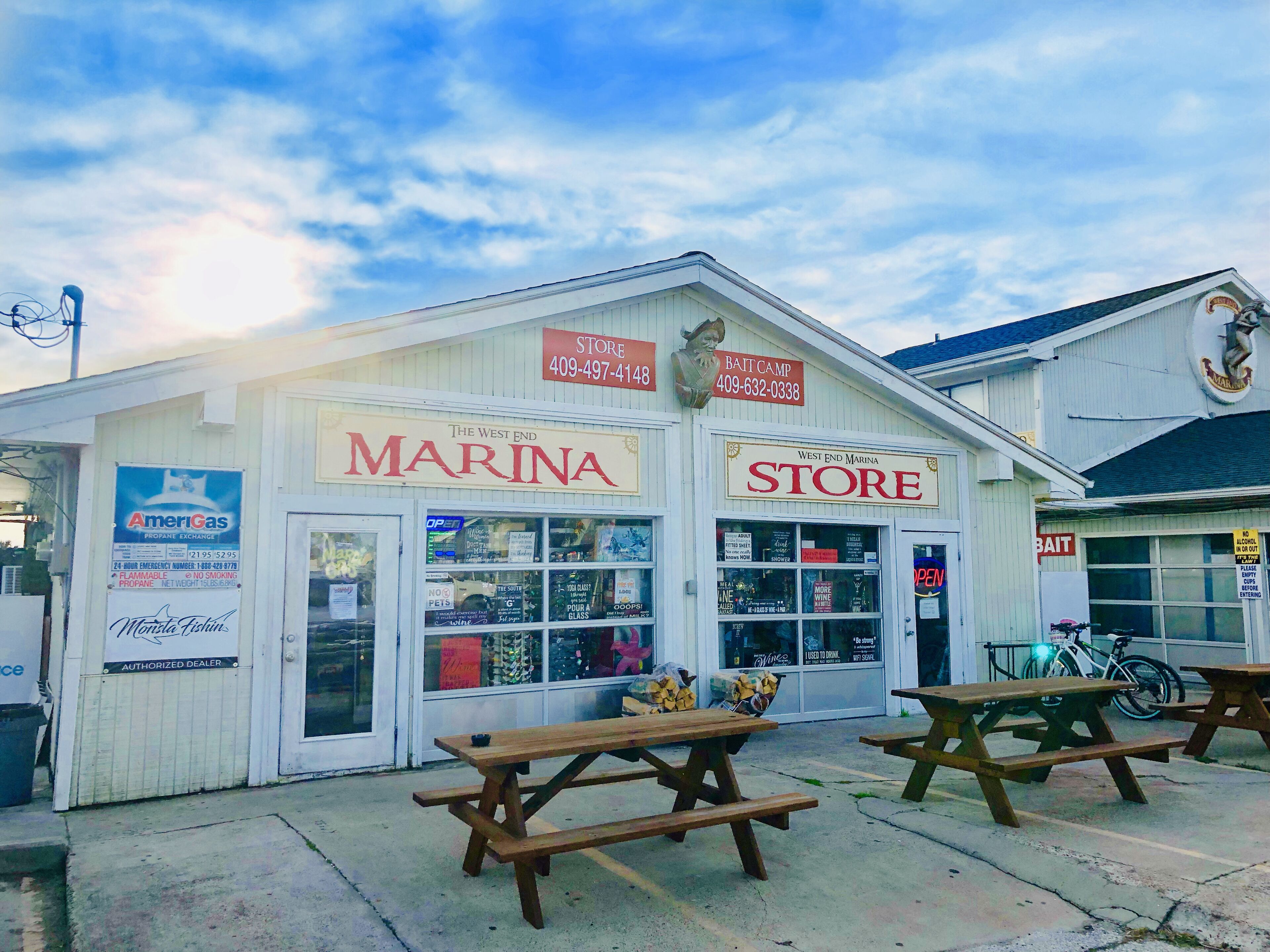A waterfront store with outdoor seating and a clear view of the water.