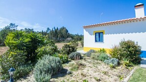 A small, single-story house with a white and yellow exterior, a blue window, and a red-tiled roof. - Digne Orange Villa, Pool, BBQ (Rogil, Aljezur)