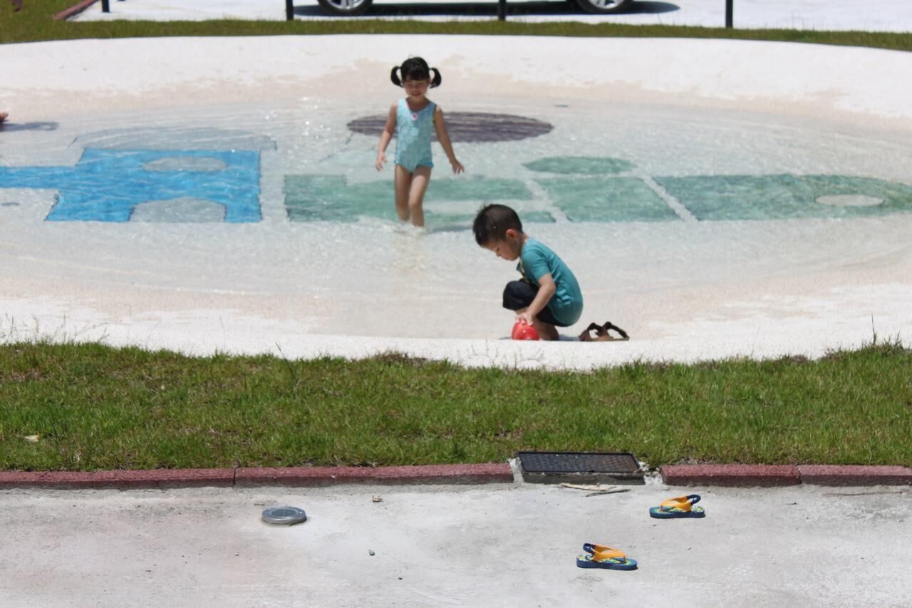A playground with a water play area.