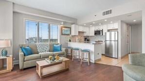 A modern apartment with a living room, kitchen, and dining area. - Palace 1503 (Myrtle Beach)
