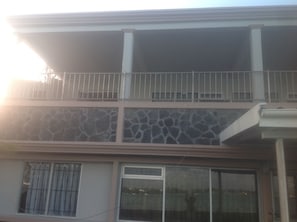 Enjoy the view from the upper floor balcony with a metal railing overlooking the street below.