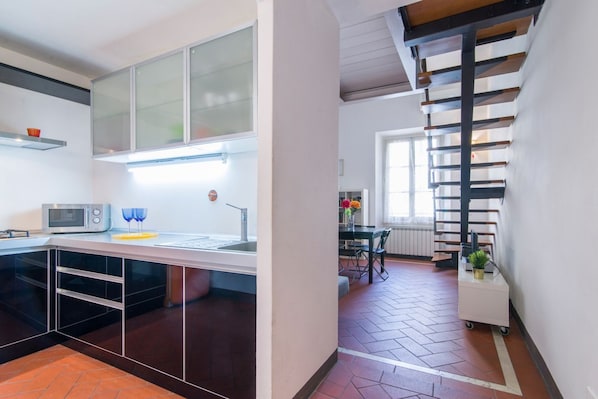 A modern kitchen with a microwave, sink, and cabinets.
