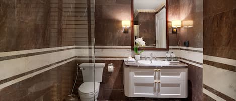 A modern bathroom with a toilet, sink, and mirror.