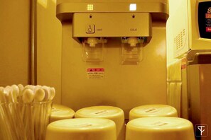 A refrigerator with a water dispenser and several bottles of milk. - T-Boutique Hostel (Bangkok)