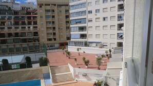 A rooftop pool area with lounge chairs, potted plants, and a staircase leading to an upper level. - A37 APOLO 4 ESC 4 4º 16 (Calpe)