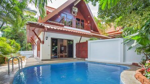 A house with a swimming pool, a balcony, and a red roof. - Unique Thai Style 4BR Pool Villa Nikkie (Rawai)