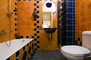 A bathroom with a bathtub, sink, and toilet.