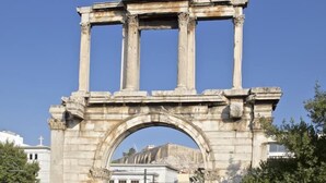 An ancient stone archway with columns, likely part of a historical site. - A Diamont with amazing view (Athens)