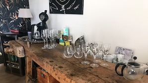 A rustic wooden bar with various glassware and a coffee maker. - La Roseraie (Sentheim)