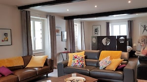 A living room with two sofas, a coffee table, and a statue. - La Roseraie (Sentheim)