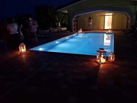 Una piscina al aire libre de temporada, sombrillas