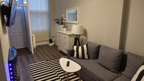 A modern living room with a grey sofa, a black and white striped rug, and a white lamp. - First - Slateford House Apartment (Edinburgh)