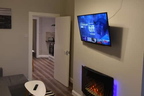 Appartement classique, 1 très grand lit et 1 canapé-lit, accessible aux personnes à mobilité réduite | Salle de séjour | Téléviseur connecté, foyer, Netflix