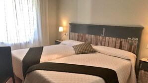 A double bed with a headboard labeled "NATURE NO. 259" in a hotel room. - Valle de San Emiliano (San Emiliano)