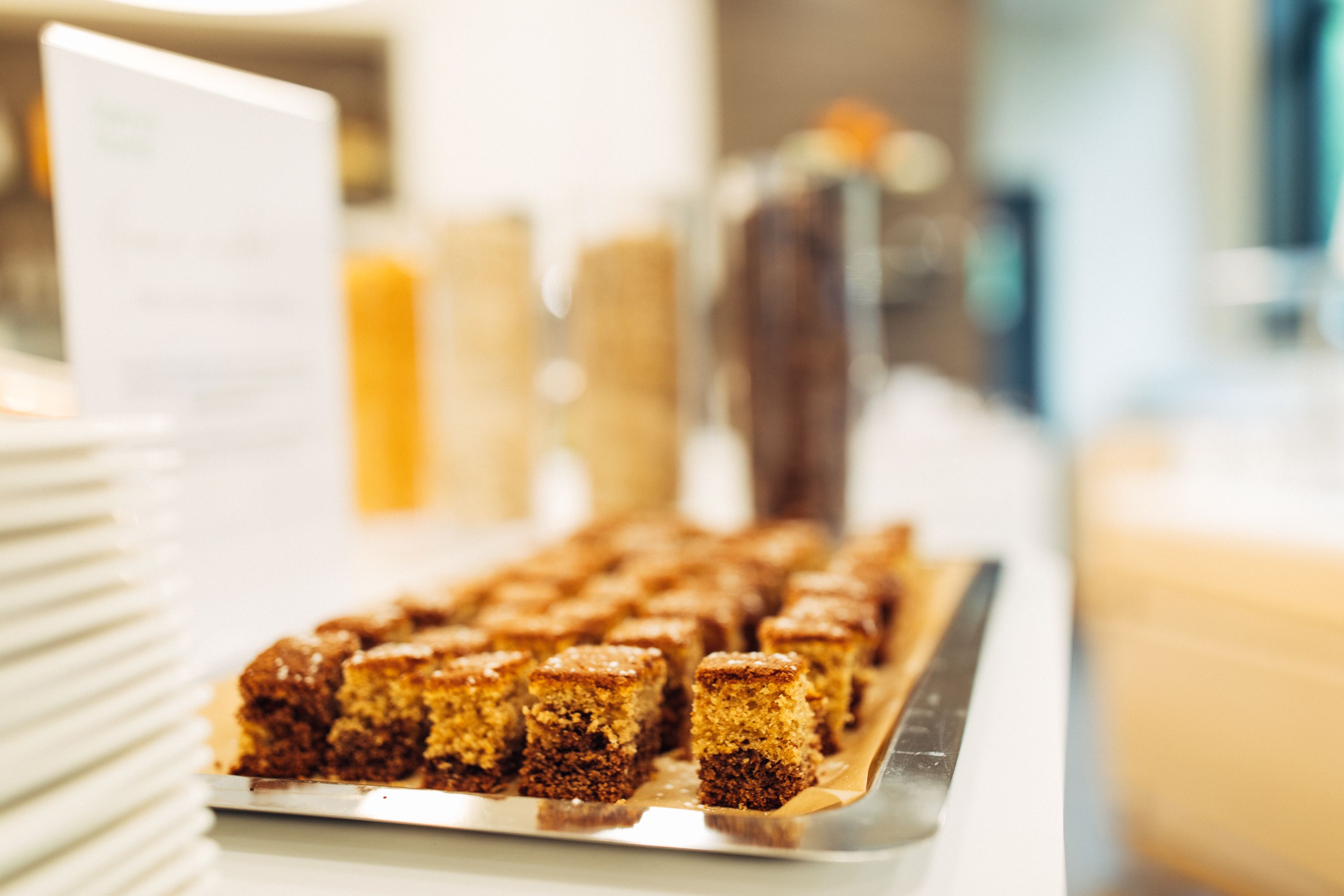 A tray of square-shaped desserts on a table.