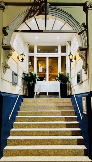 A staircase leading to a breakfast room with a sign above the door. - Great Malvern Hotel (Malvern)