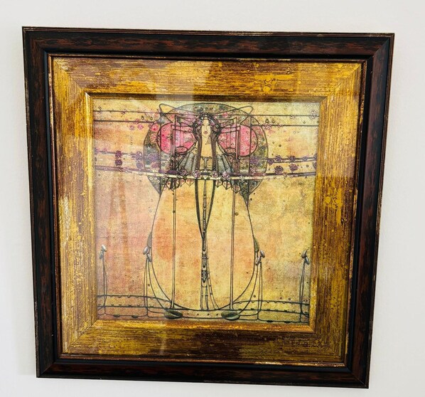 A framed artwork with a geometric design and floral elements. - Great Malvern Hotel (Malvern)