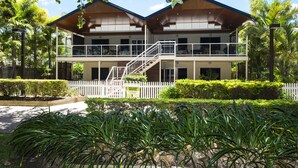A two-story building with a balcony and a staircase leading to the upper floor. - Picnic Bay Apartments Unit 1 (Picnic Bay)